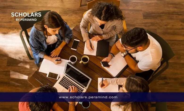 Group of students collaborating at a table while preparing their application for the Master Mind Scholarship in Belgium.