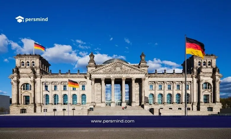 Panoramic view of the Reichstag building in Berlin with German flags waving, used as a symbolic image for the Heidelberg Laureate Forum (HLF) in Germany.